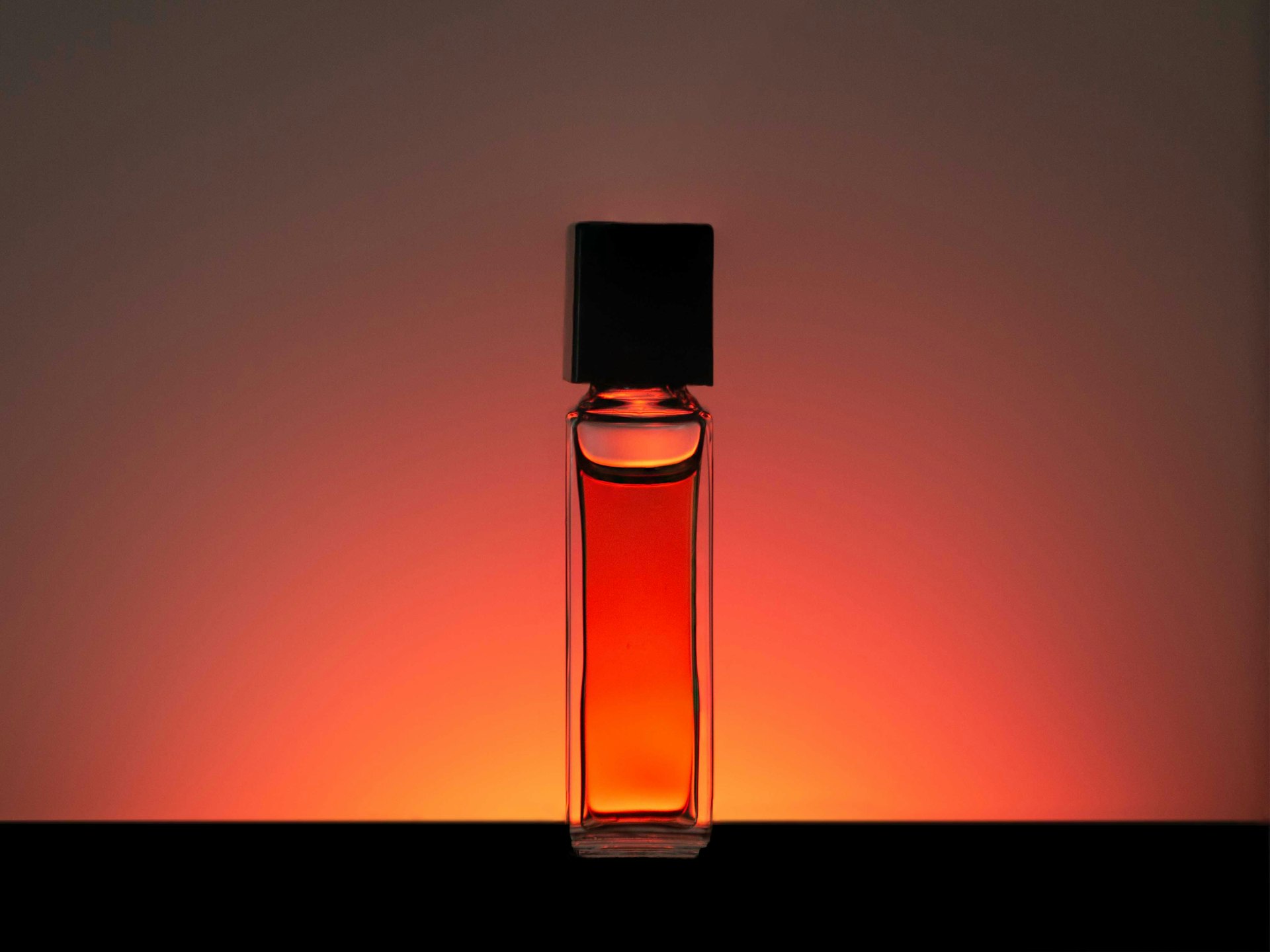 clear glass bottle with orange liquid